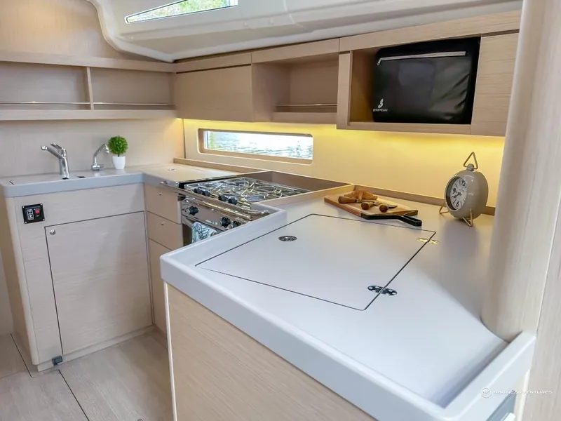 Slide: The Image of Modern kitchen in 2024 Beneteau Oceanis 40.1 yacht with stove, sink, and microwave. - 7
