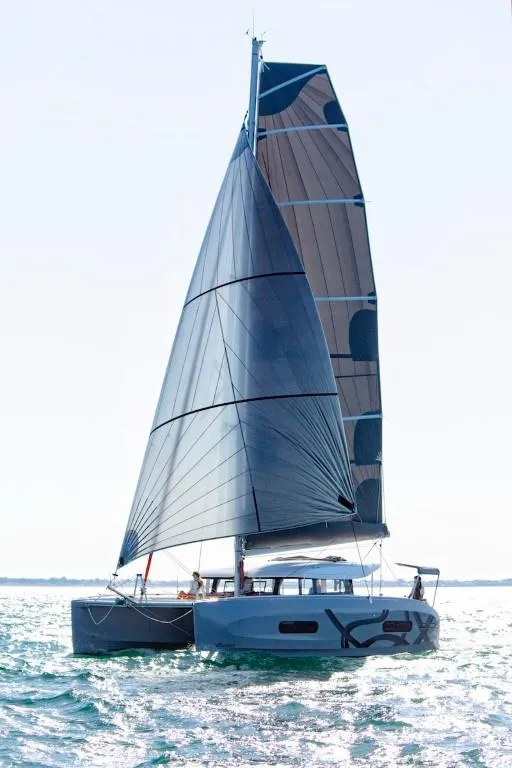 Slide: The Image of 2024 Excess 11 catamaran sailing on open water. - 12