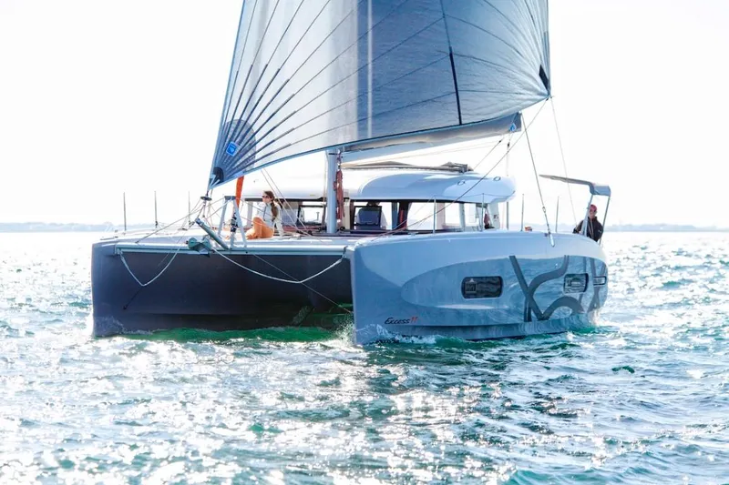 Slide: The Image of 2024 Excess 11 catamaran sailing on open water. - 7