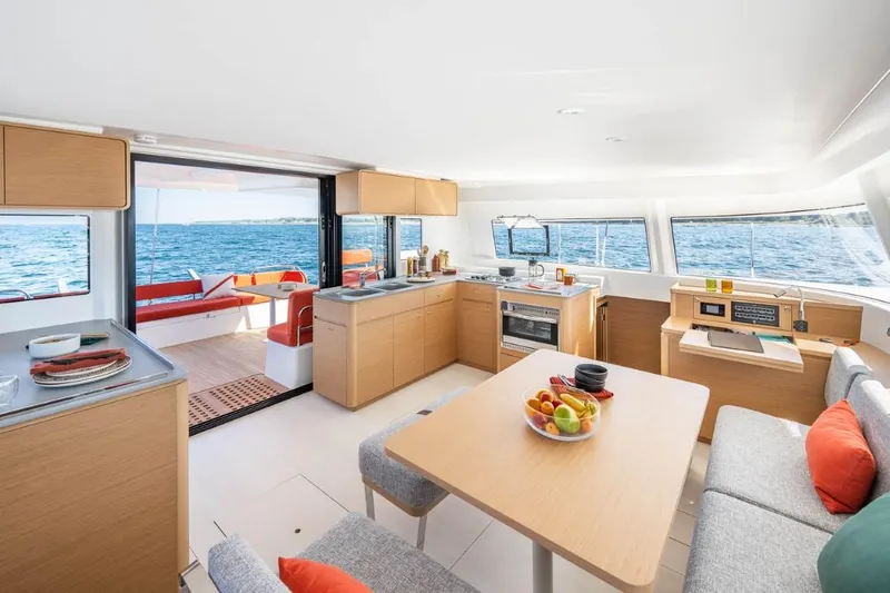 Slide: The Image of Modern interior of 2024 Excess 14 catamaran with kitchen and dining area. - 2