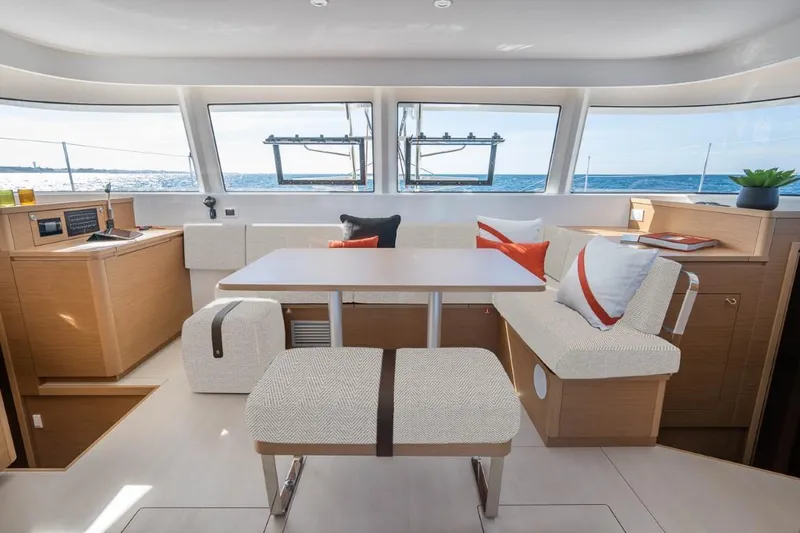 Slide: The Image of 2024 Excess 14 yacht interior with modern seating and ocean view. - 9