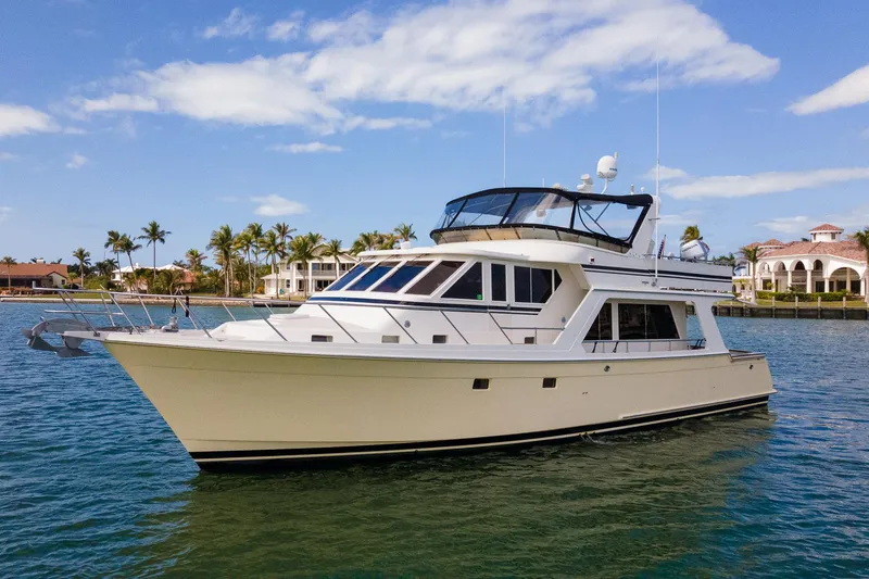 Slide: The Image of 1998 Offshore Yachts 54 Pilot House cruising in a scenic coastal area. - 1