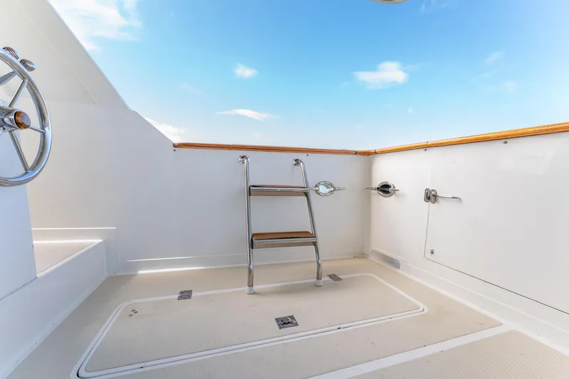 Slide: The Image of 1998 Offshore Yachts 54 Pilot House deck with ladder and blue sky. - 28