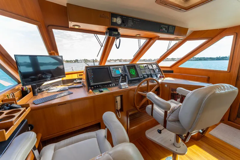 Slide: The Image of 1998 Offshore Yachts 54 Pilot House helm with navigation equipment and panoramic windows. - 41