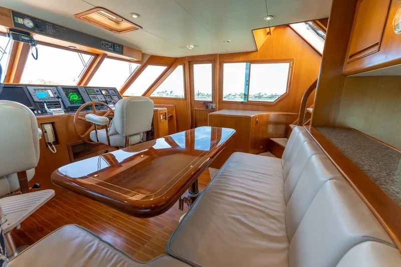 Slide: The Image of Luxurious interior of 1998 Offshore Yachts 54 Pilot House with helm station and seating area. - 46