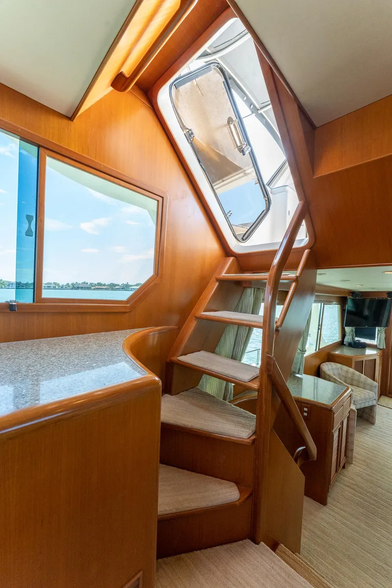 Slide: The Image of Interior of 1998 Offshore Yachts 54 Pilot House with wooden stairs and open hatch. - 48