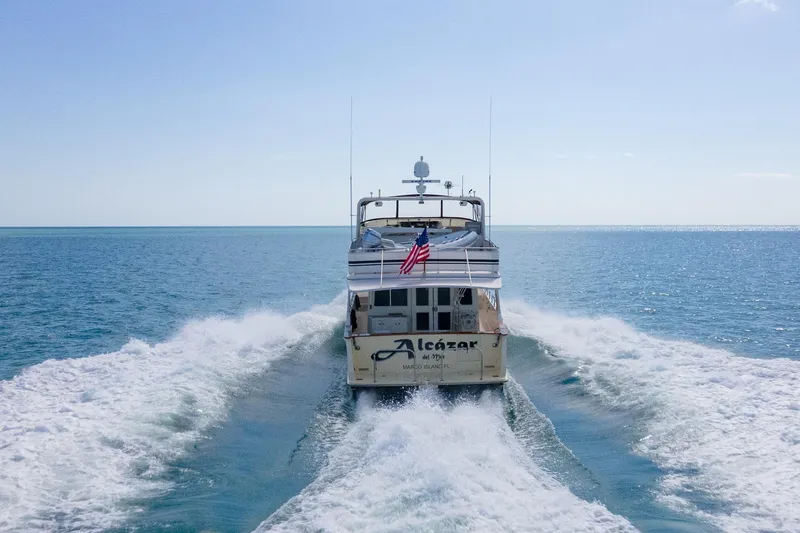 Slide: The Image of 1998 Offshore Yachts 54 Pilot House cruising on open water. - 8