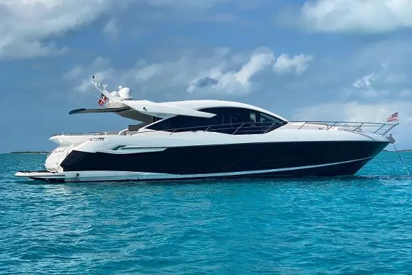 Slide: The Image of 2020 Sunseeker Predator 74 XPS luxury yacht on clear blue water. - 1