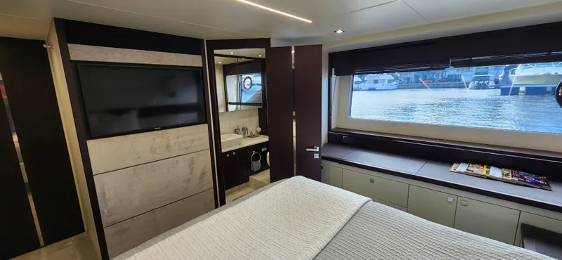 Slide: The Image of Luxurious bedroom interior of 2020 Sunseeker Predator 74 XPS yacht with waterfront view. - 11