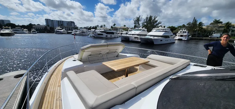 Slide: The Image of Sunseeker Predator 74 XPS 2020 yacht with spacious deck seating in a marina. - 23