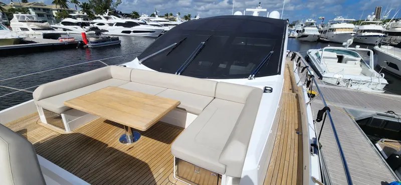 Slide: The Image of Sunseeker Predator 74 XPS 2020 yacht with spacious outdoor seating and table at marina. - 24