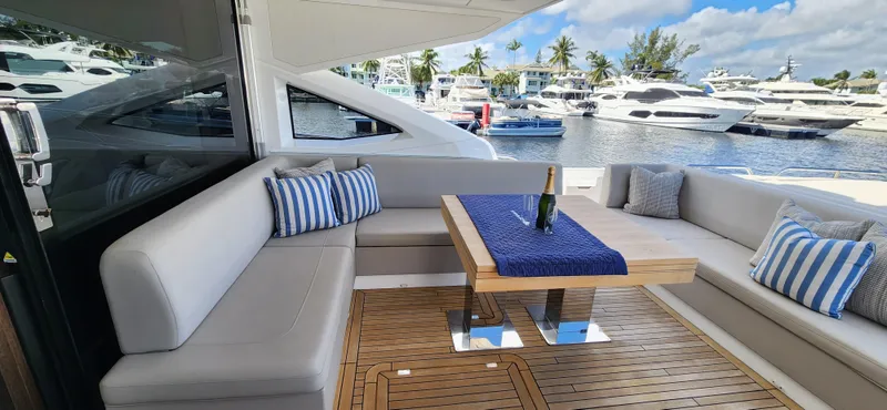 Slide: The Image of Luxury seating area on 2020 Sunseeker Predator 74 XPS yacht with marina view. - 38