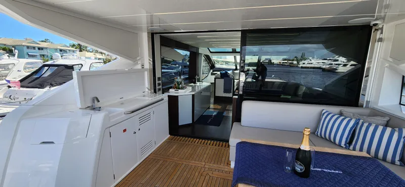 Slide: The Image of Sunseeker Predator 74 XPS 2020 yacht interior with outdoor seating and champagne. - 39