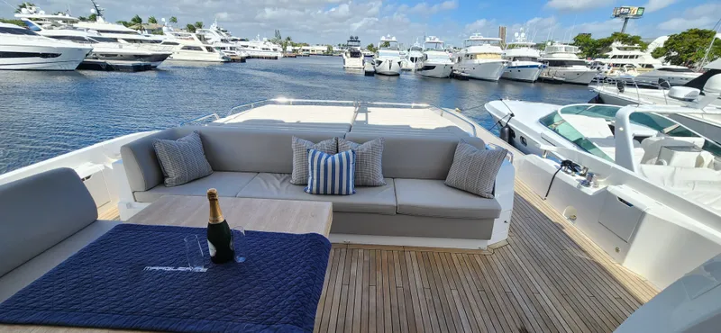 Slide: The Image of Luxury Sunseeker Predator 74 XPS yacht, 2020 model, docked with elegant seating and champagne. - 40