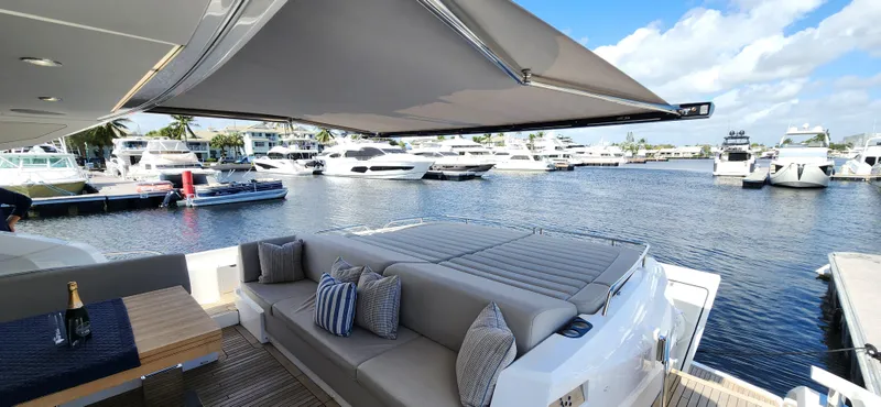Slide: The Image of Sunseeker Predator 74 XPS 2020 yacht with luxurious seating and marina view. - 41
