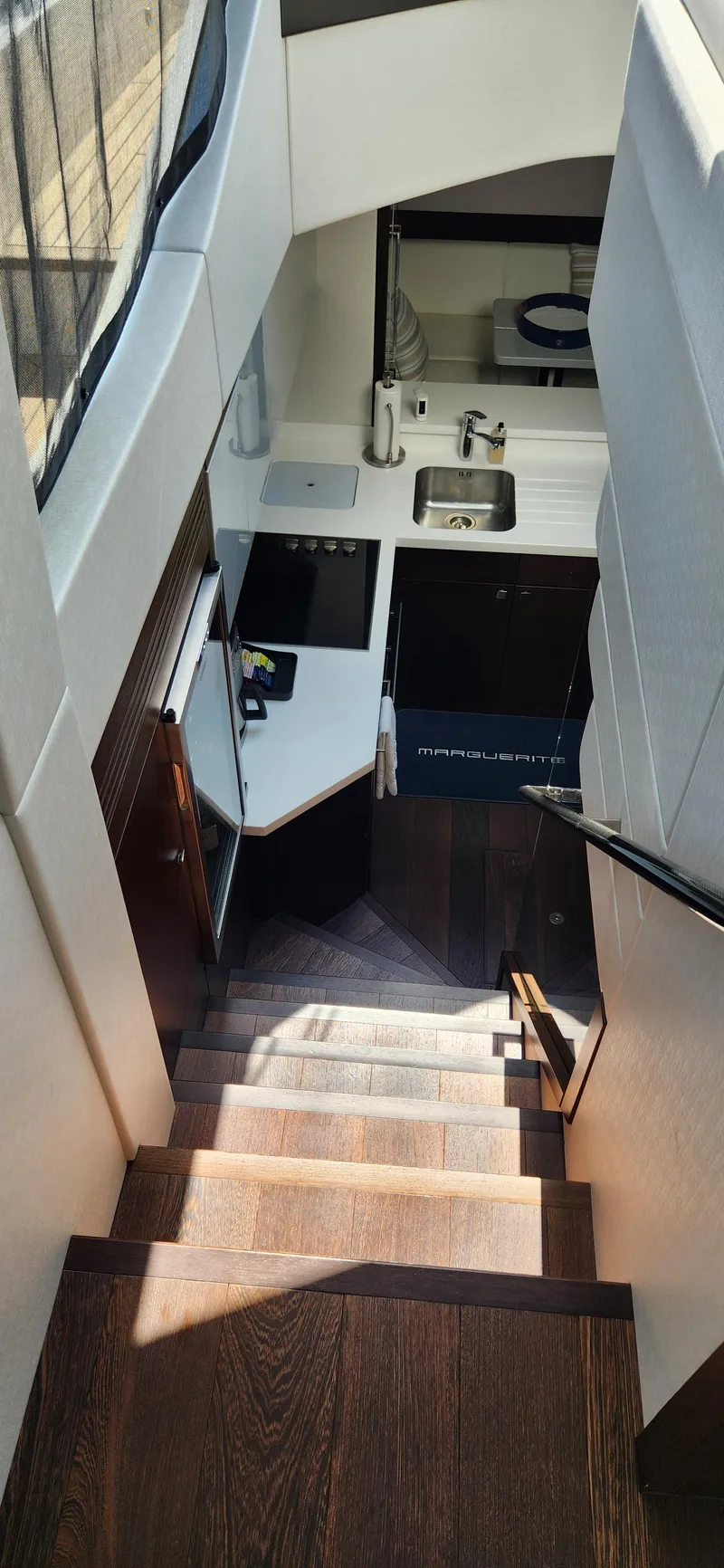 Slide: The Image of Staircase leading to the kitchen area in a 2020 Sunseeker Predator 74 XPS yacht. - 46