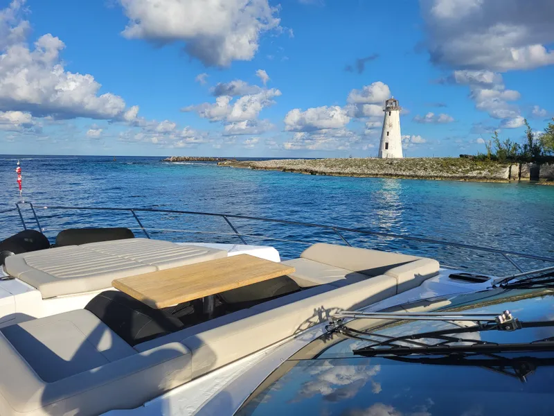 Slide: The Image of Sunseeker Predator 74 XPS 2020 yacht near a lighthouse on a sunny day. - 5