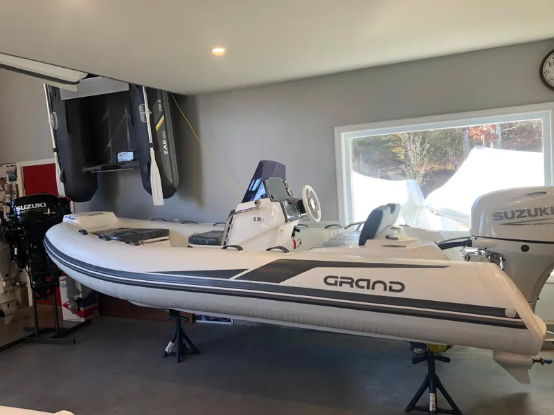 The Image of 2023 Grand G 420 inflatable boat in showroom with Suzuki outboard motor. - 0