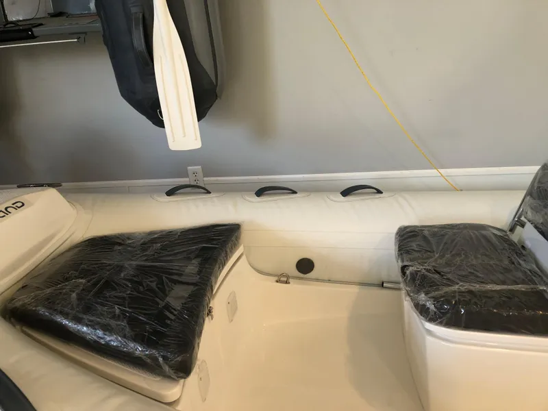 Slide: The Image of 2023 Grand G 420 boat interior with black seats and white hull. - 5