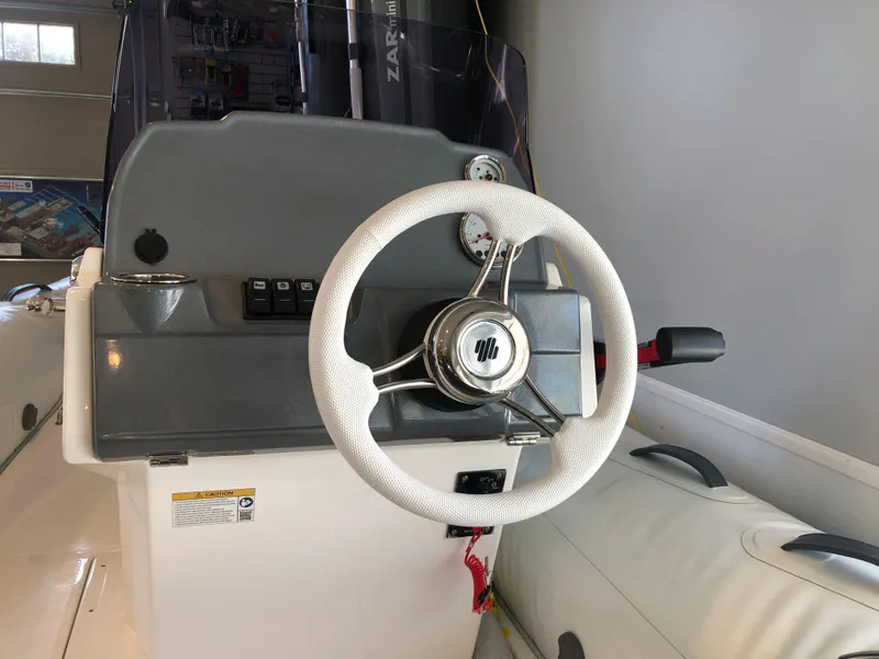 Slide: The Image of 2023 Grand G 420 boat steering console with white wheel and control panel. - 7