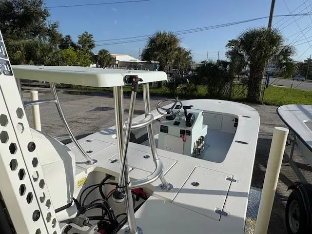 Slide: The Image of 2025 Mitzi Skiffs 17 boat with elevated platform and steering console, parked outdoors. - 5