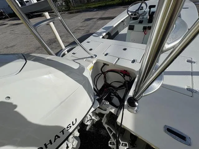 Slide: The Image of 2025 Mitzi Skiffs 17 boat with Tohatsu engine, showcasing helm and deck details. - 7