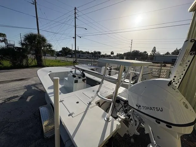 Slide: The Image of 2025 Mitzi Skiffs 17 boat with Tohatsu engine, parked outdoors under clear sky. - 9