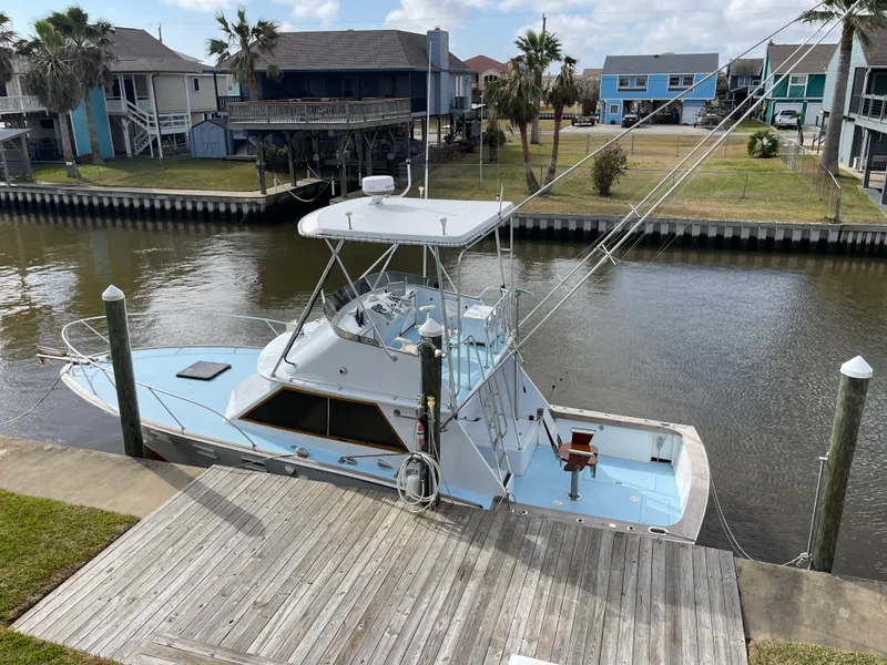 Slide: The Image of 1975 Custom 36 Matlack Tournament SF boat docked by waterfront homes. - 10
