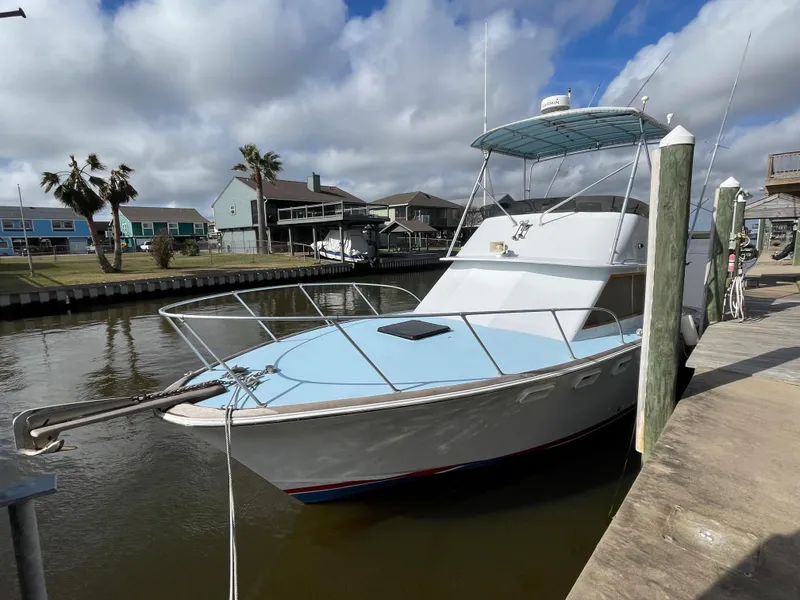 Slide: The Image of 1975 Custom 36 Matlack Tournament SF boat docked in a residential canal. - 11