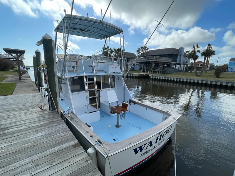 Slide: The Image of 1975 Custom 36 Matlack Tournament SF boat docked by waterfront homes. - 14