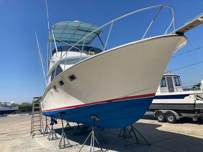 Slide: The Image of 1975 Custom 36 Matlack Tournament SF boat on stands in a marina. - 2