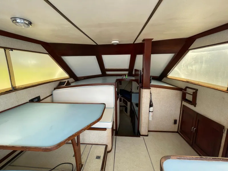 Slide: The Image of Interior of 1975 Custom 36 Matlack Tournament SF boat with dining area and helm. - 25