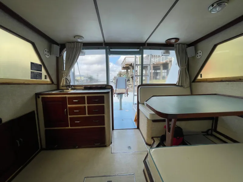 Slide: The Image of Interior of a 1975 Custom 36 Matlack Tournament SF boat with dining area and storage. - 32