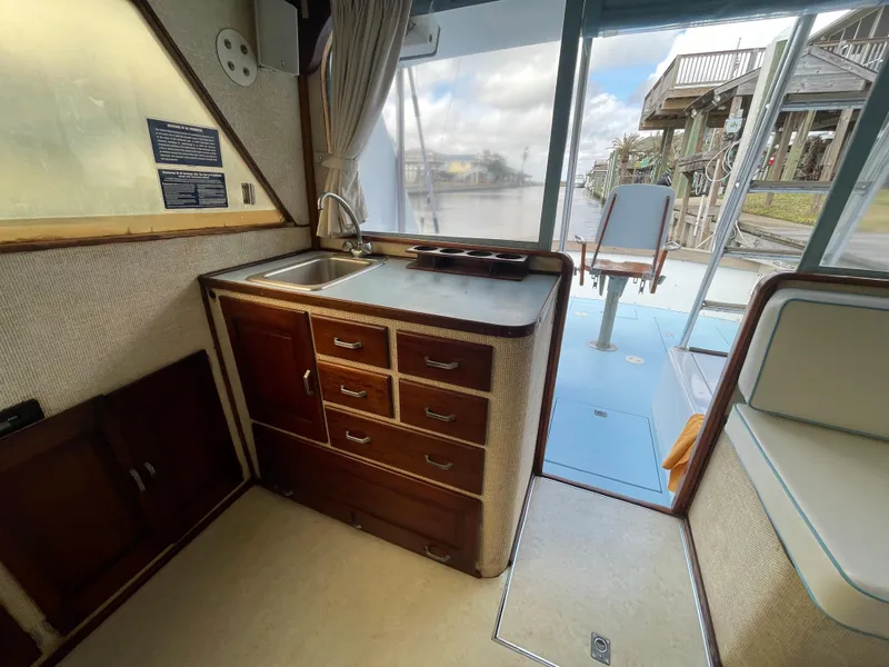 Slide: The Image of 1975 Custom 36 Matlack Tournament SF boat interior with wooden cabinetry and sink. - 34