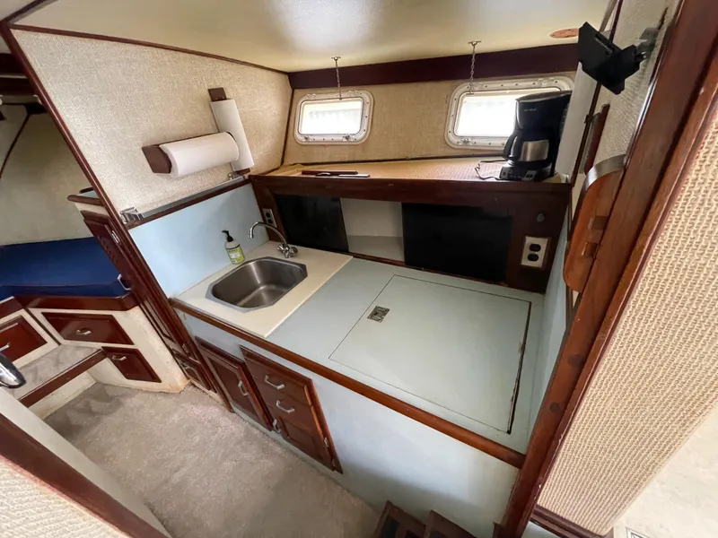 Slide: The Image of 1975 Custom 36 Matlack Tournament SF boat kitchen with sink, storage, and coffee maker. - 37