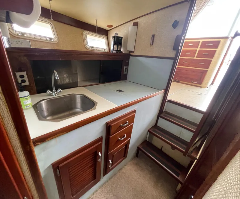 Slide: The Image of 1975 Custom 36 Matlack Tournament SF boat kitchen with sink and stairs. - 38