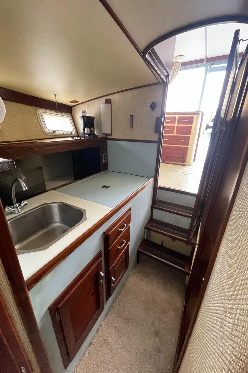 Slide: The Image of 1975 Custom 36 Matlack Tournament SF boat interior with kitchenette and stairs. - 39
