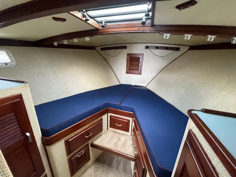 Slide: The Image of 1975 Custom 36 Matlack Tournament SF cabin with blue cushions and wooden cabinetry. - 41