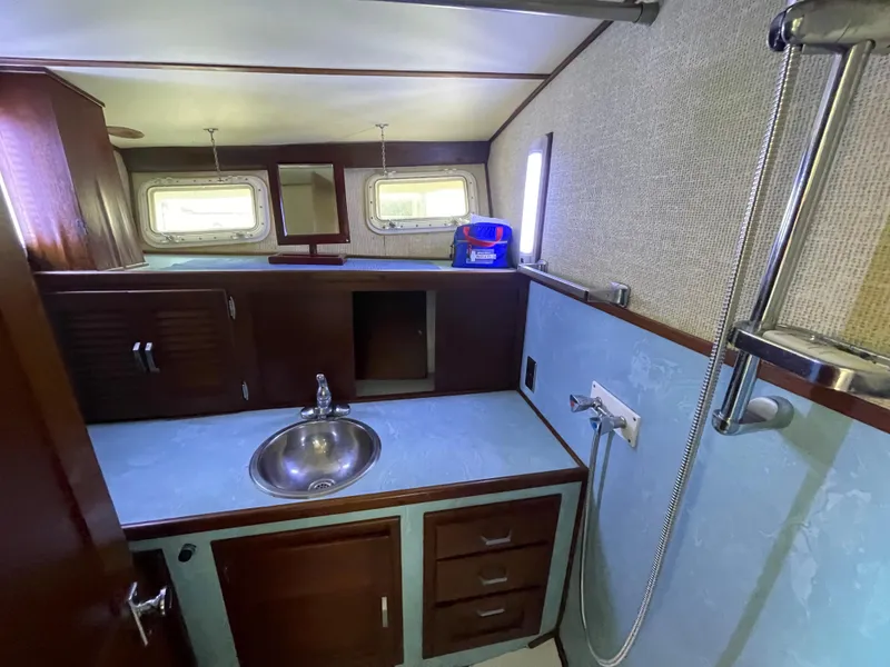 Slide: The Image of 1975 Custom 36 Matlack Tournament SF boat bathroom with sink and shower. - 46