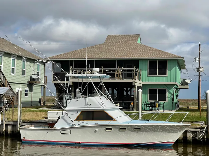 Slide: The Image of 1975 Custom 36 Matlack Tournament SF boat docked near waterfront house. - 8