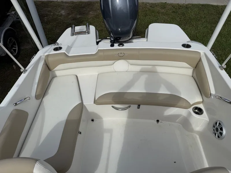 Slide: The Image of 2017 Stingray 191DC boat interior with beige seating and cup holders. - 4