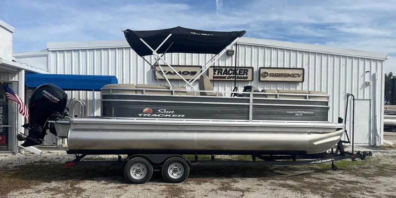 The Image of 2023 Sun Tracker Party Barge 22 RF DLX pontoon boat on trailer outside dealership. - 0