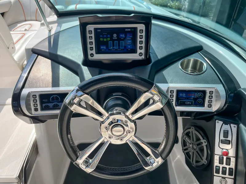 Slide: The Image of 2013 MasterCraft XStar dashboard with touchscreen display and modern controls. - 11