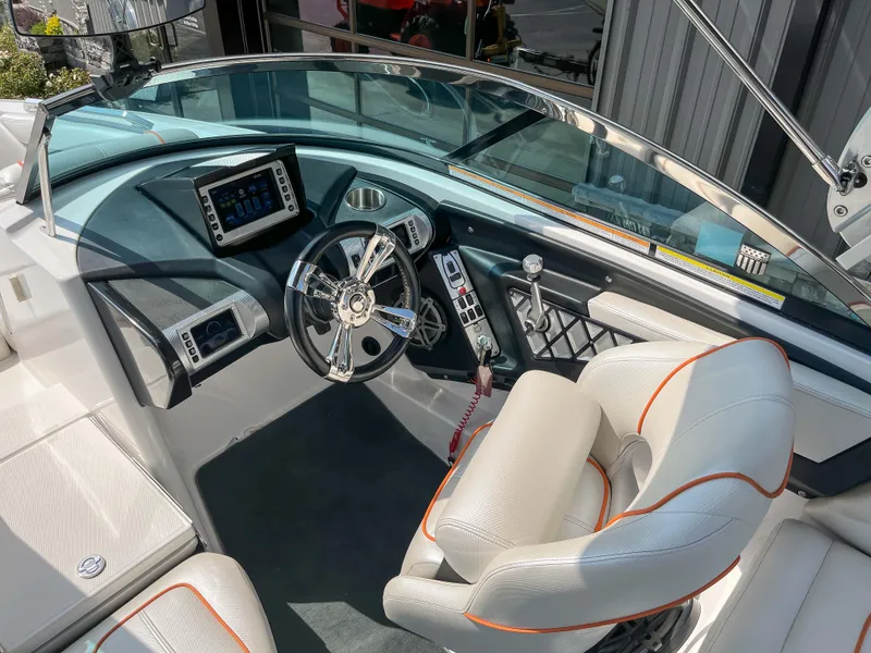 Slide: The Image of 2013 MasterCraft XStar boat cockpit with modern steering wheel and dashboard. - 13