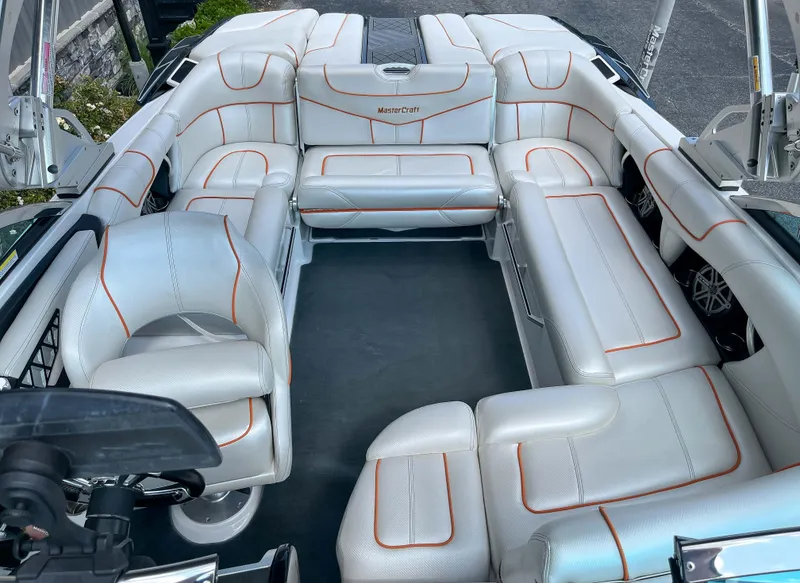 Slide: The Image of 2013 MasterCraft XStar boat with white and orange interior seating. - 15