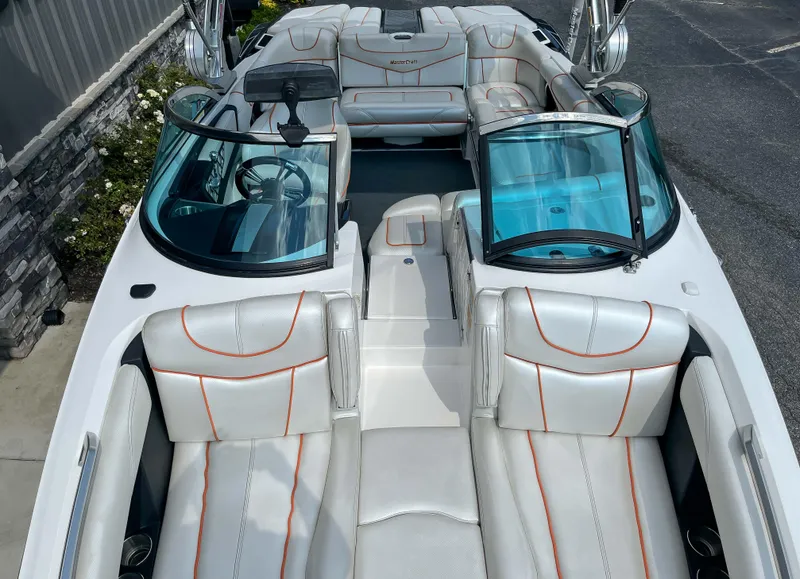 Slide: The Image of 2013 MasterCraft XStar boat interior with white and orange upholstery. - 16