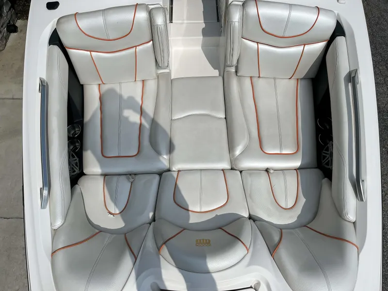 Slide: The Image of 2013 MasterCraft XStar boat interior with white and orange-stitched seats. - 17