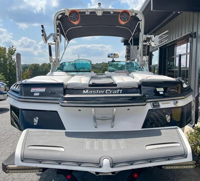 Slide: The Image of 2013 MasterCraft XStar boat rear view with swim platform and wakeboard tower. - 6