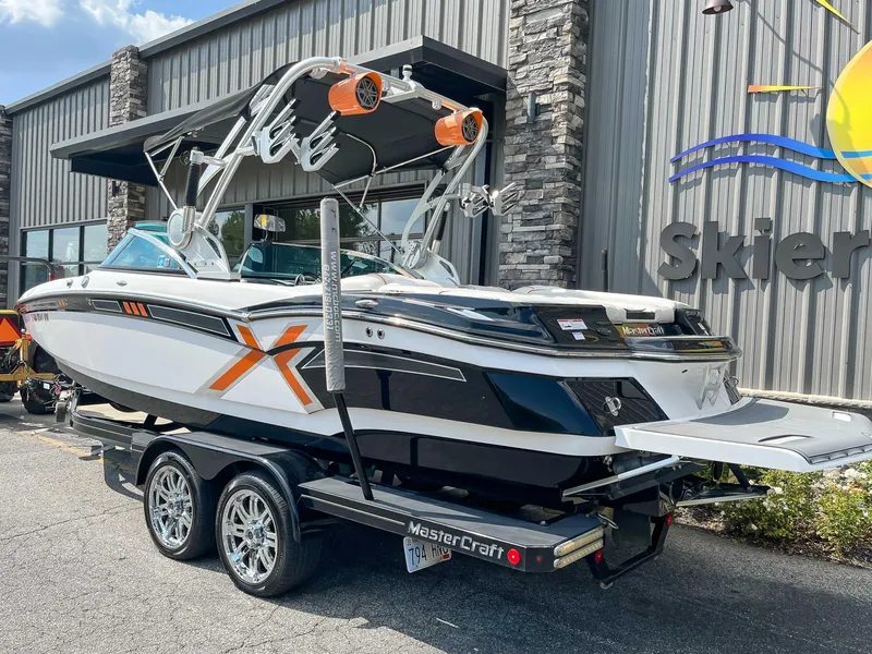 Slide: The Image of 2013 MasterCraft XStar boat on trailer outside dealership. - 7
