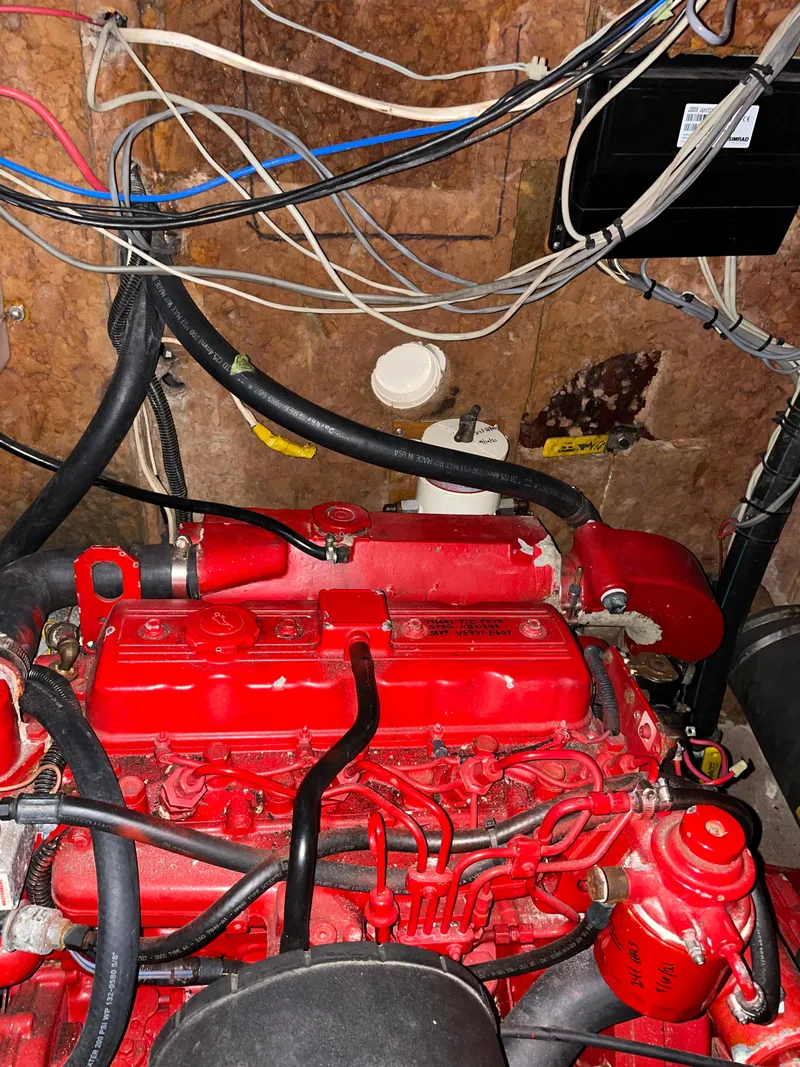 Slide: The Image of Red engine of a 1983 Najad 371 American CC sailboat with surrounding wires. - 17